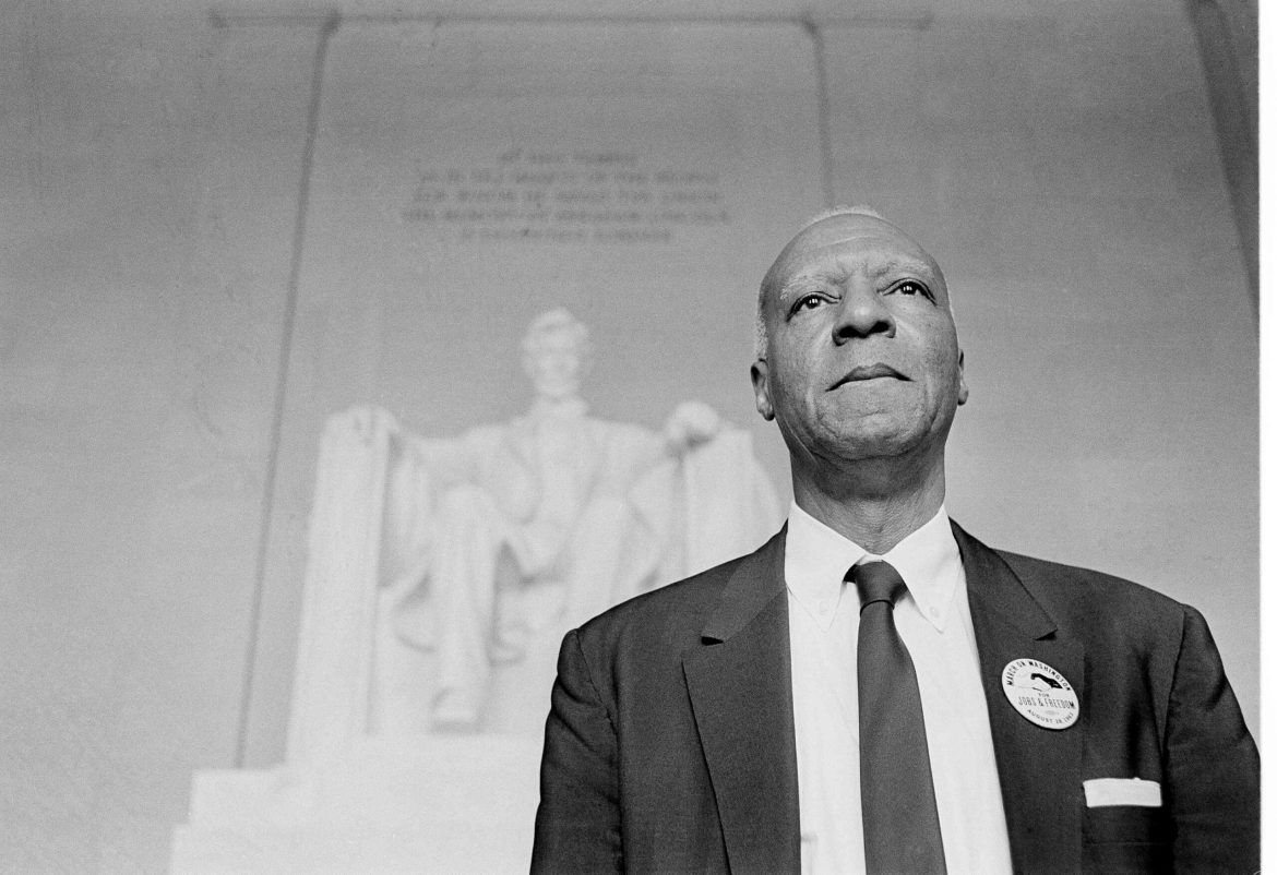 A. Philip Randolph, one of the chairmen for the March On Washington, stands in front of the statue of Abraham Lincoln at the Lincoln Memorial after a parade through the streets of the capital, Aug. 28, 1963.