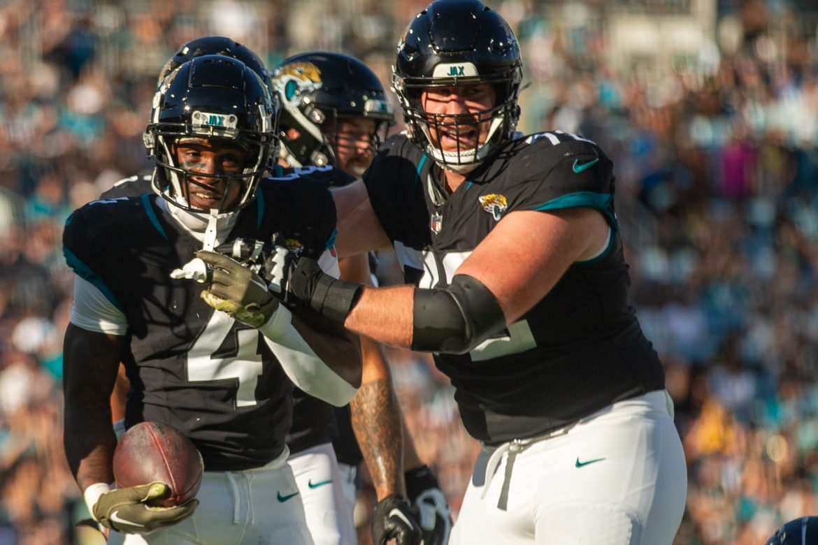 Jacksonville Jaguars offensive guard Walker Little (72) celebrates with running back Tank Bigsby (4) after a first down against the Tennessee Titans on Nov. 19, 2023. 