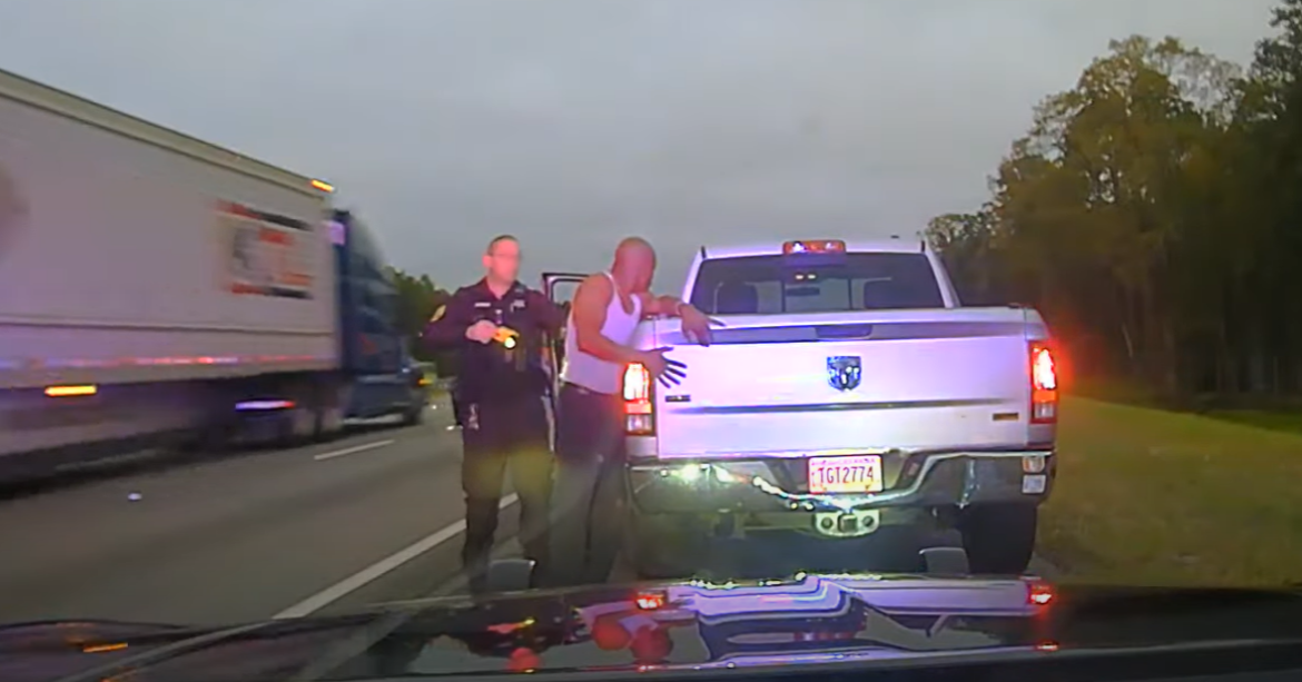 Leonard Cure places his hands on the back of his truck as Sgt. Buck Aldridge prepares to fire his Taser during a traffic stop Oct. 16, 2023, in Camden County, Georgia. 