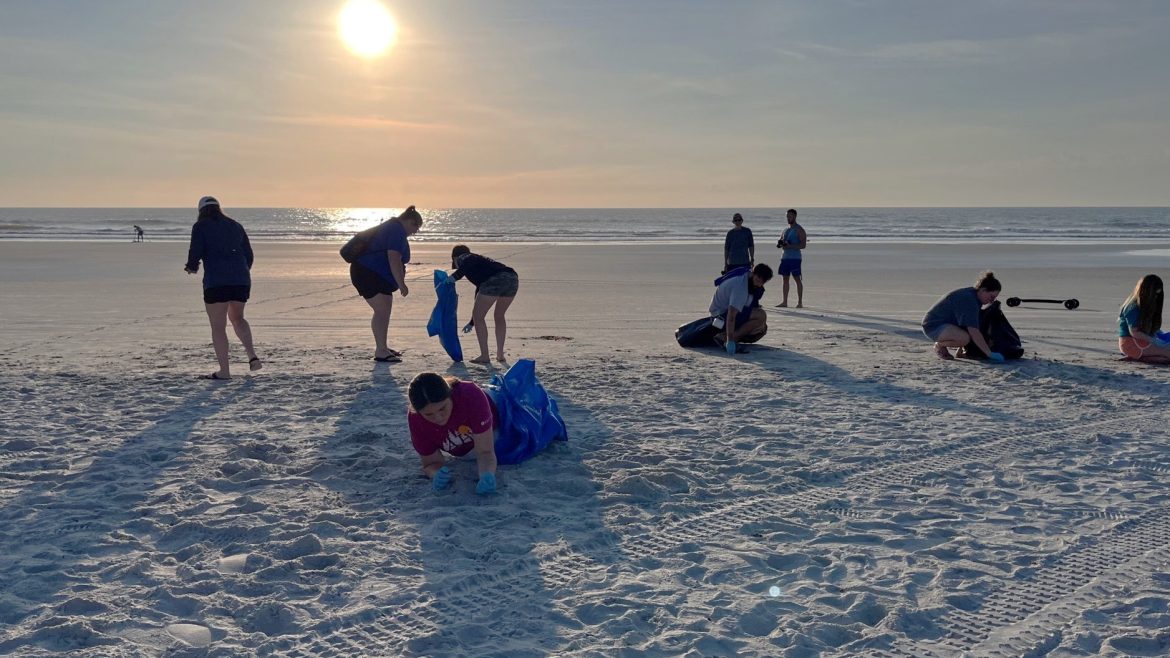 Volunteers clean a Jacksonville beachfront during a recent St. Johns River Celebration. 