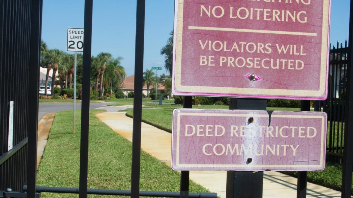 A sign on the gate of a deed restricted community