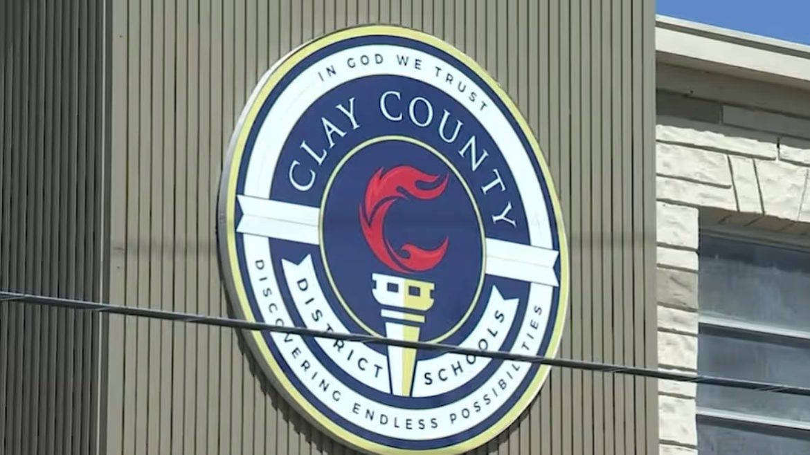 The Clay County school district emblem hangs on a building