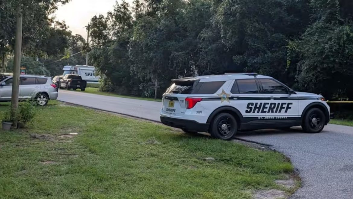 A police car parked where St. Johns County deputies shot a man to death.